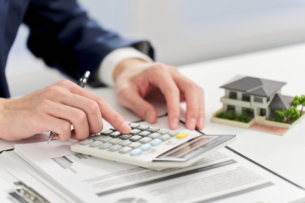 Professional accountant working while using calculator